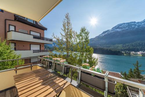 a balcony of a building with a view of a lake at Chesa Bellavista - St. Moritz in St. Moritz