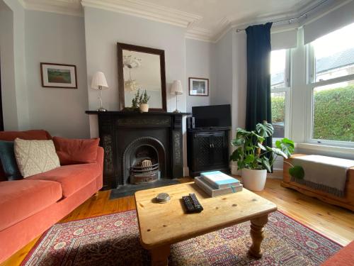 a living room with a couch and a fireplace at Cardiff - Home from Home in Cardiff
