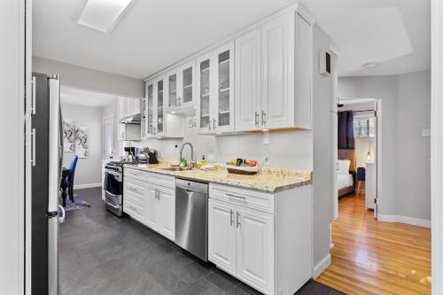 cocina con armarios blancos y encimera en Stunning 4 BD Home near Tilles Park - JZ Vacation Rentals, en Richmond Heights