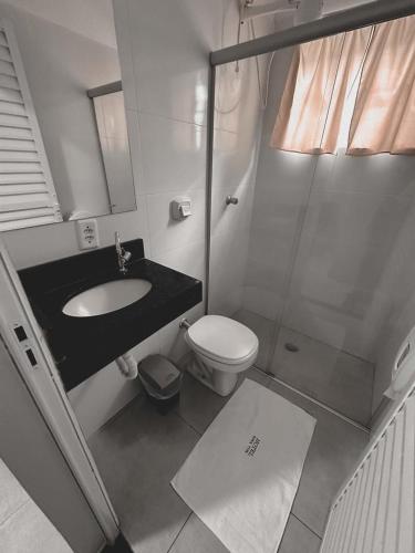 a bathroom with a sink and a toilet and a shower at Hotel Rosa Viva in Barretos