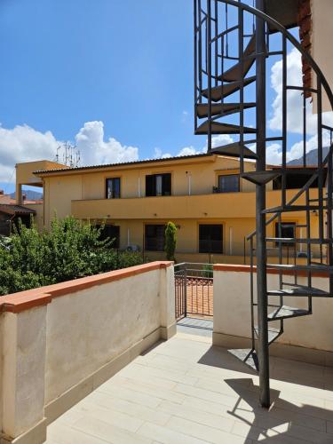 a metal spiral staircase in front of a building at IsolaHome in Isola delle Femmine