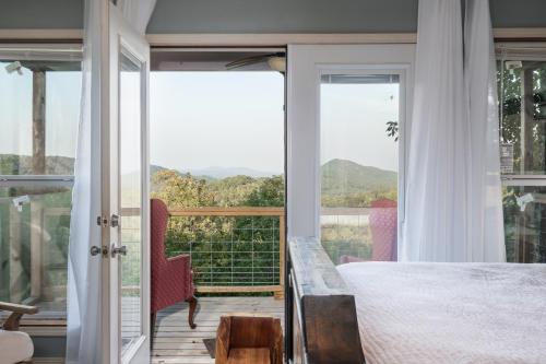 a bedroom with a bed and a balcony with a view at Misty Mountain Cabin Spectacular Scenic Escape by Caddo River in Glenwood
