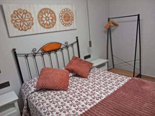 1 dormitorio con 1 cama con 2 almohadas en Apartamento de la Haya, junto al Teatro Romano, en Mérida