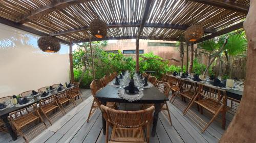 a dining room with a table and chairs at Diamante K - Inside Tulum National Park in Tulum