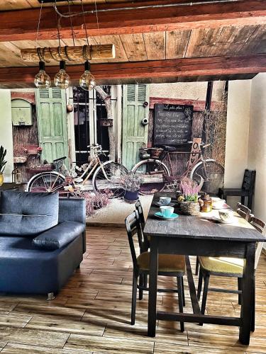 a dining room with a table and chairs and bikes at Malinowa Chatka in Jankowice