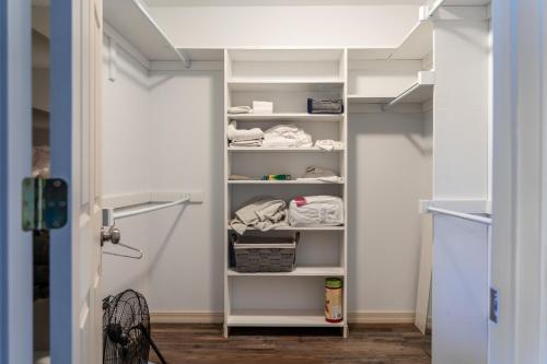 a walk in closet with white shelves in a room at Misty Mountain Cabin Spectacular Scenic Escape by Caddo River in Glenwood