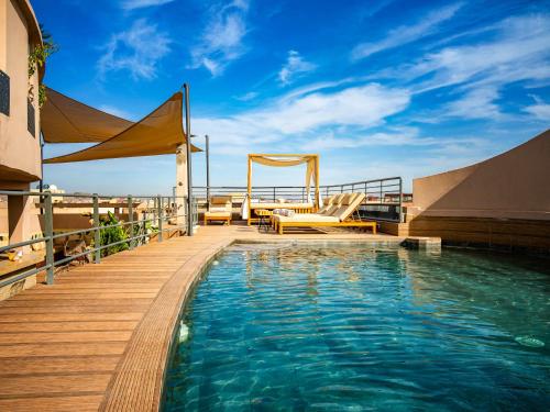 a deck with a pool on top of a building at Fashion Boutique Hotel in Marrakesh