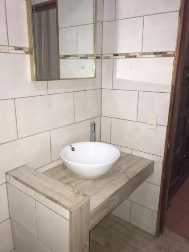 a bathroom with a white sink and a mirror at Casa Caribbean Coconut in Cahuita
