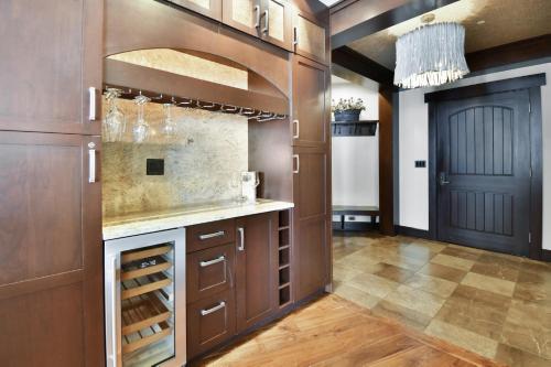 a kitchen with wooden cabinets and a wine cellar at Flagstaff #301 in Park City