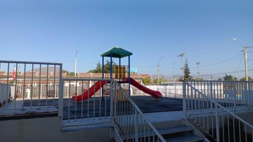 a playground with a slide in a parking lot at Marina La Serena, Playa Cuatro Esquinas in La Serena