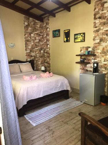 a bedroom with a bed with pink flowers on it at Casa Caribbean Coconut in Cahuita