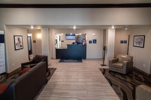 a waiting room with couches and chairs in a hospital at Cobblestone Inn & Suites -Springfield in Springfield