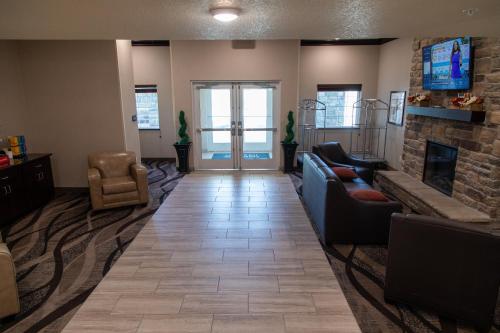 a living room with a couch and a fireplace at Cobblestone Inn & Suites -Springfield in Springfield