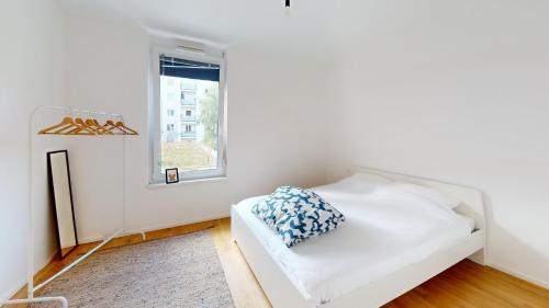a white bed in a room with a window at PA14 Modern apartment with a private garage near Schönbrunn Palace T5 in Vienna