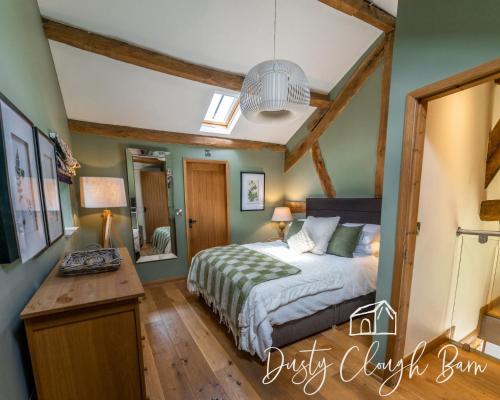 a bedroom with a bed and a desk in it at Dusty Clough Barn in Preston