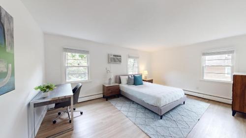 a bedroom with a bed and a desk and a computer at Furnished 2br Pool Gym Parking Pb in Newark