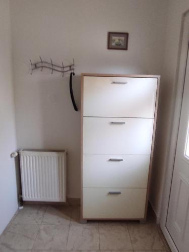 a white dresser in a corner of a room at Apartman ZAGREB,REBRO,MAKSIMIR,CENTAR Marko in Zagreb