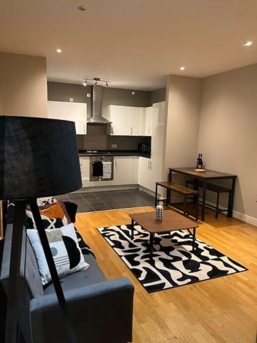 a living room with a couch and a table at Modern 2 Bed Apartment Next To Station + Parking in Beckenham