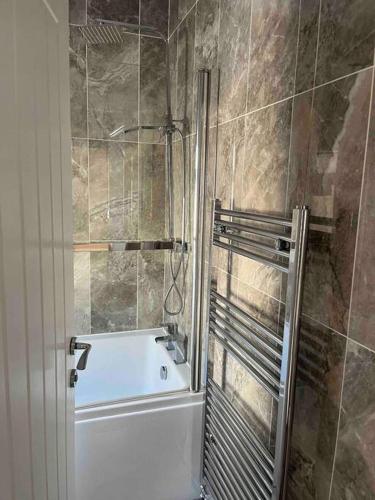 a bathroom with a shower and a bath tub at Darlington Home Away From Home in Darlington