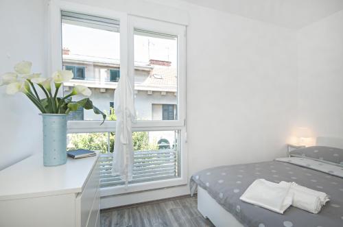 Postel nebo postele na pokoji v ubytování City Smart Apartment