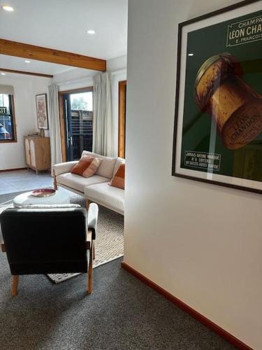 a living room with a couch and a picture on a wall at Woolshed 17 - Self Catering Accommodation in Havelock North