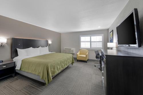 a hotel room with a bed and a flat screen tv at Quality Inn Kettleman City near Hwy 41 in Kettleman City