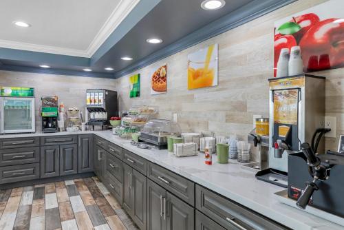 a kitchen with gray cabinets and a counter at Quality Inn Kettleman City near Hwy 41 in Kettleman City