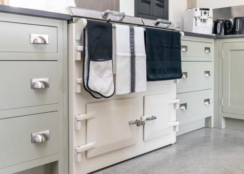 a kitchen with white drawers and towels at The Grain Store Lewes in Lewes