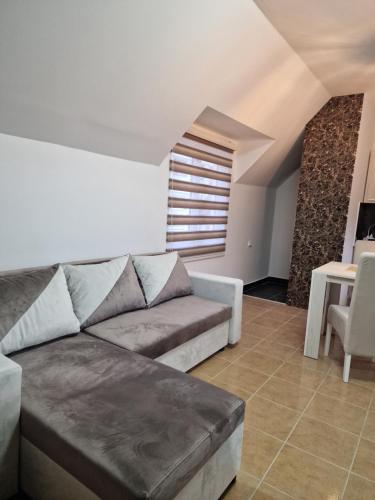 a living room with a couch and a table at Apartman Kruna in Priboj