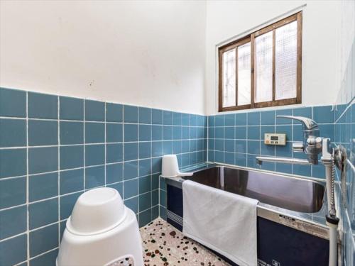 a bathroom with blue tiles and a sink at Chachamaru Osaka Castle Park - Vacation STAY 15422 in Osaka