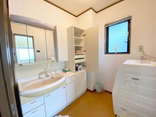 a white bathroom with a sink and a window at cold - Vacation STAY 69755v in Kumamoto