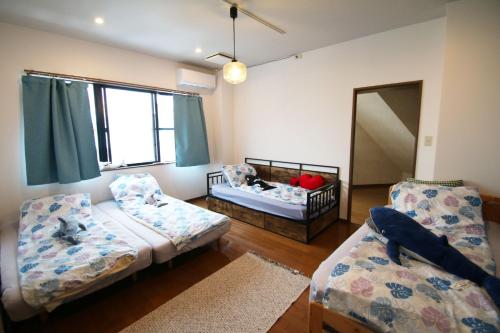 a small room with two beds and a mirror at cold - Vacation STAY 69755v in Kumamoto