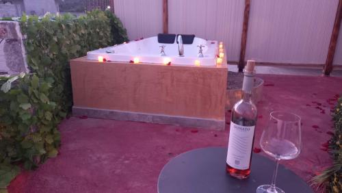 a bottle of wine sitting on a table next to a hot tub at Hotel Peña Florencia in Bernal