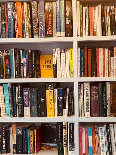 a book shelf filled with lots of books at Beautiful London Victorian house, sleeps 12 in London