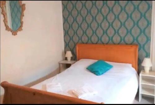 a bedroom with a bed with a green pillow on it at Townhouse Wexford in Wexford