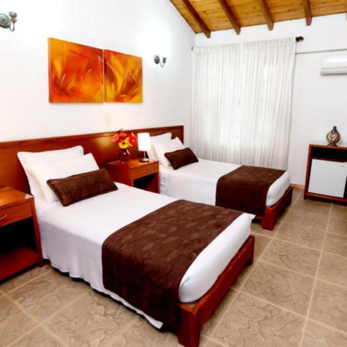 two beds in a hotel room with two beds sidx sidx sidx at los rafeles 5 in Guaymas