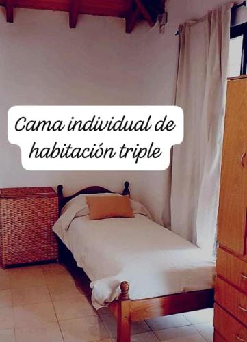 a bedroom with a bed with the words canama individual die rehabilitationutic at Lodge de Montaña in El Challao
