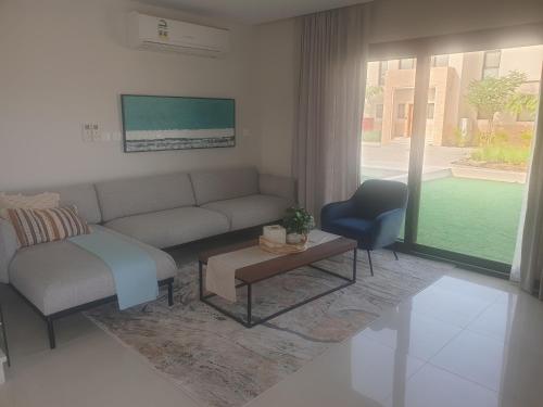 a living room with a couch and a chair at Sunrise Sifah in As Sīfah