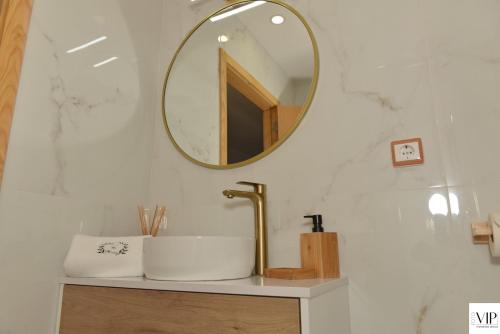 a bathroom with a sink and a mirror at Casa da Moda - Turismo de Campo in Vieira do Minho