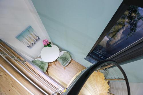 a staircase with a white table and a white vase with flowers at A101 Comfy Stylish Loft in Coventry