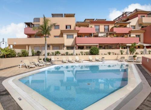 a swimming pool in front of a building at Terrazas del Duque II Hideaway in Adeje