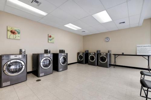 a laundry room with four washer and dryers in it at Holiday Inn Houston Downtown by IHG in Houston