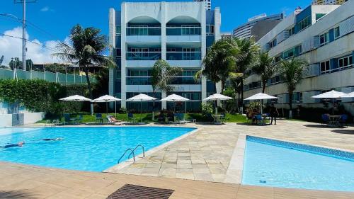 a swimming pool in front of a building at Apart-Hotel Beira Mar de Ponta Negra - Harmony Suítes in Natal