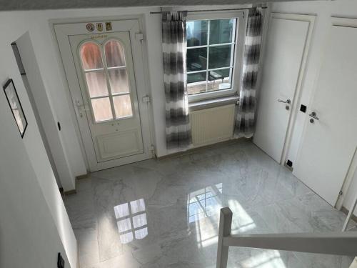 an empty room with a door and a window at Outlet Center House, Pool-Jacuzzi-Garden-Sundeck in Parndorf