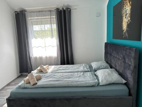 a bed sitting in a room with a window at Outlet Center House, Pool-Jacuzzi-Garden-Sundeck in Parndorf