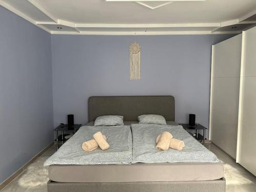 a bedroom with a bed with two pillows on it at Outlet Center House, Pool-Jacuzzi-Garden-Sundeck in Parndorf