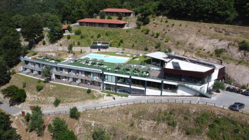an aerial view of a building with a swimming pool at DOBAU village in Vieira do Minho
