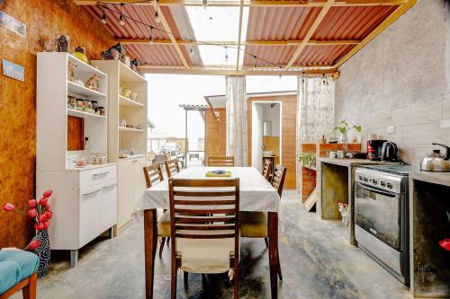 a kitchen with a table and chairs in a room at Glamping Playa Arica in Lurín