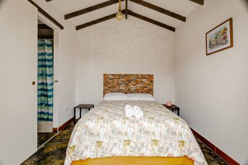 a bedroom with a bed with two white shoes on it at Glamping Playa Arica in Lurín