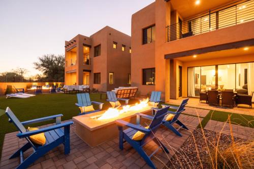 a patio with chairs and a table in front of a building at Residence 1- The Villas At Troon North Golf Club townhouse in Scottsdale